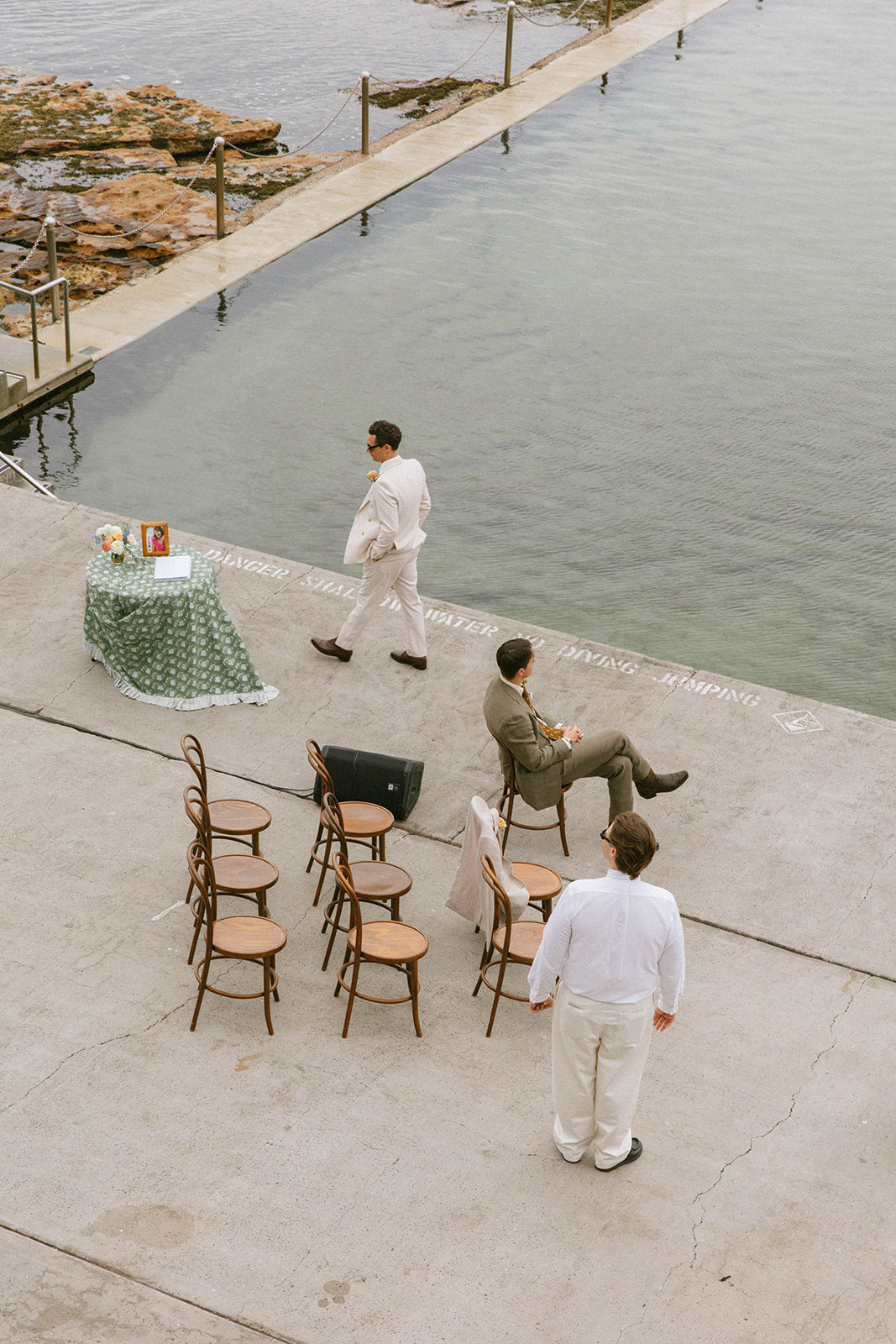 Wylie's Baths deck set for a wedding with long tables above the ocean pool