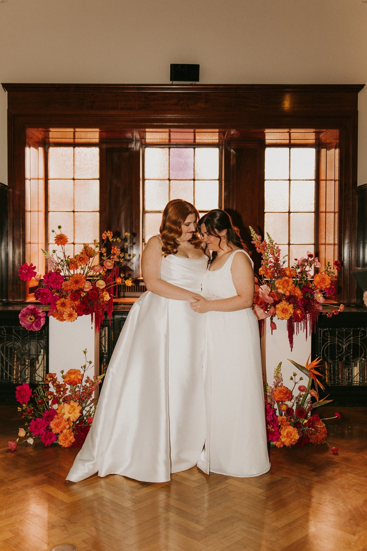Bridget and Ellie between two floral plinths in the Friends Room at the State Library of NSW