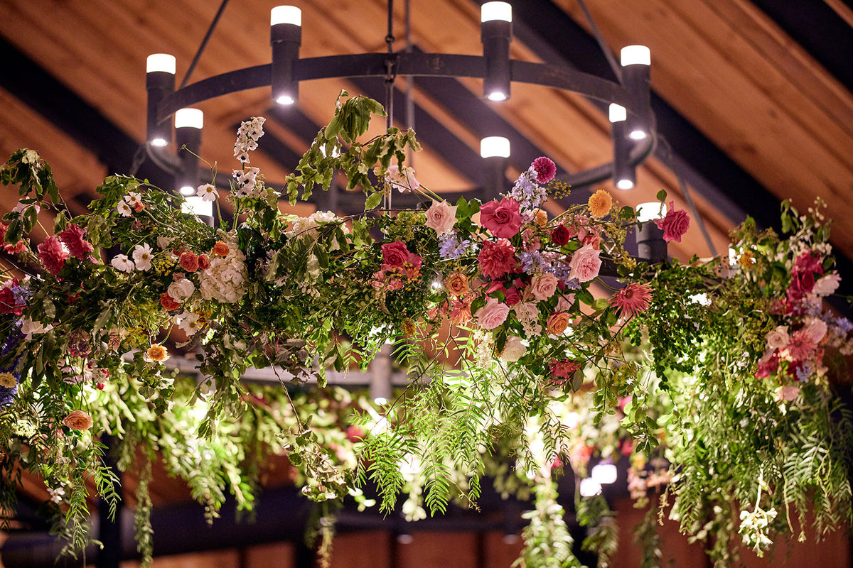 Floral installations hanging from the hoop chandeliers at The Stables, Bendooley Estate