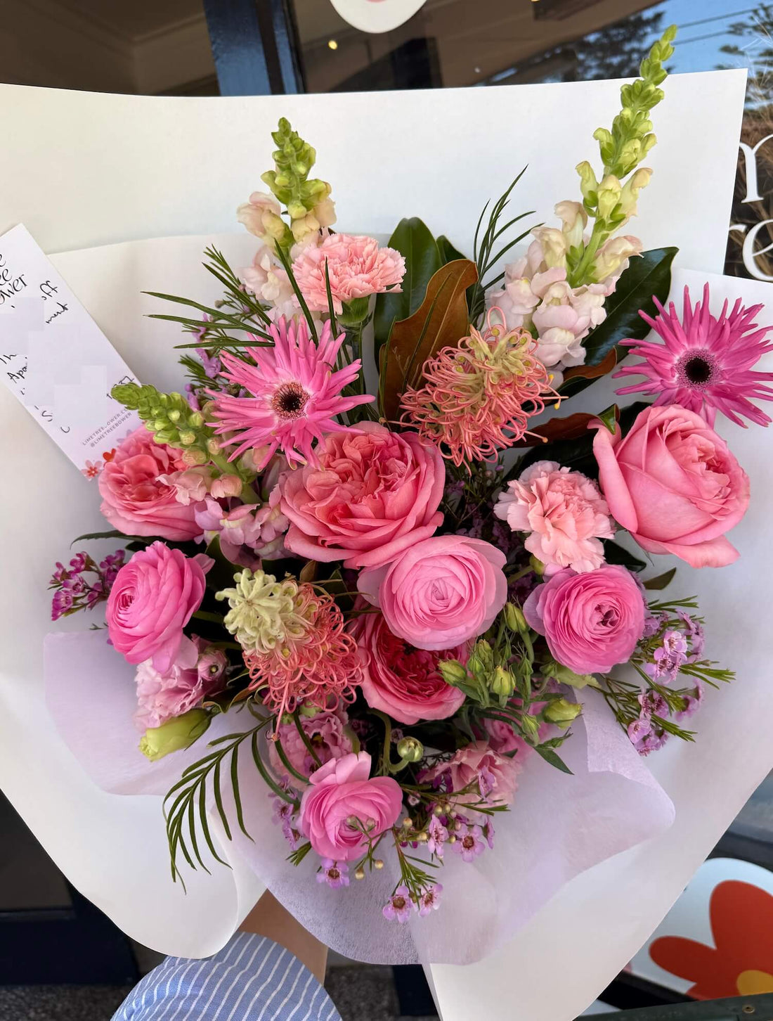 Bouquet of valentine romantic pink flowers with greenery on a white background